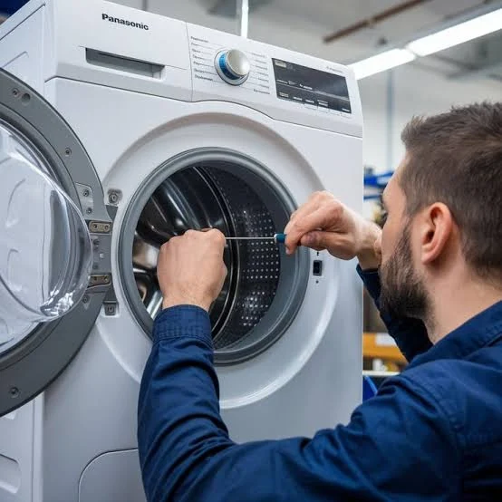Technician inspecting the drum and door opening of a front-loading washing machine